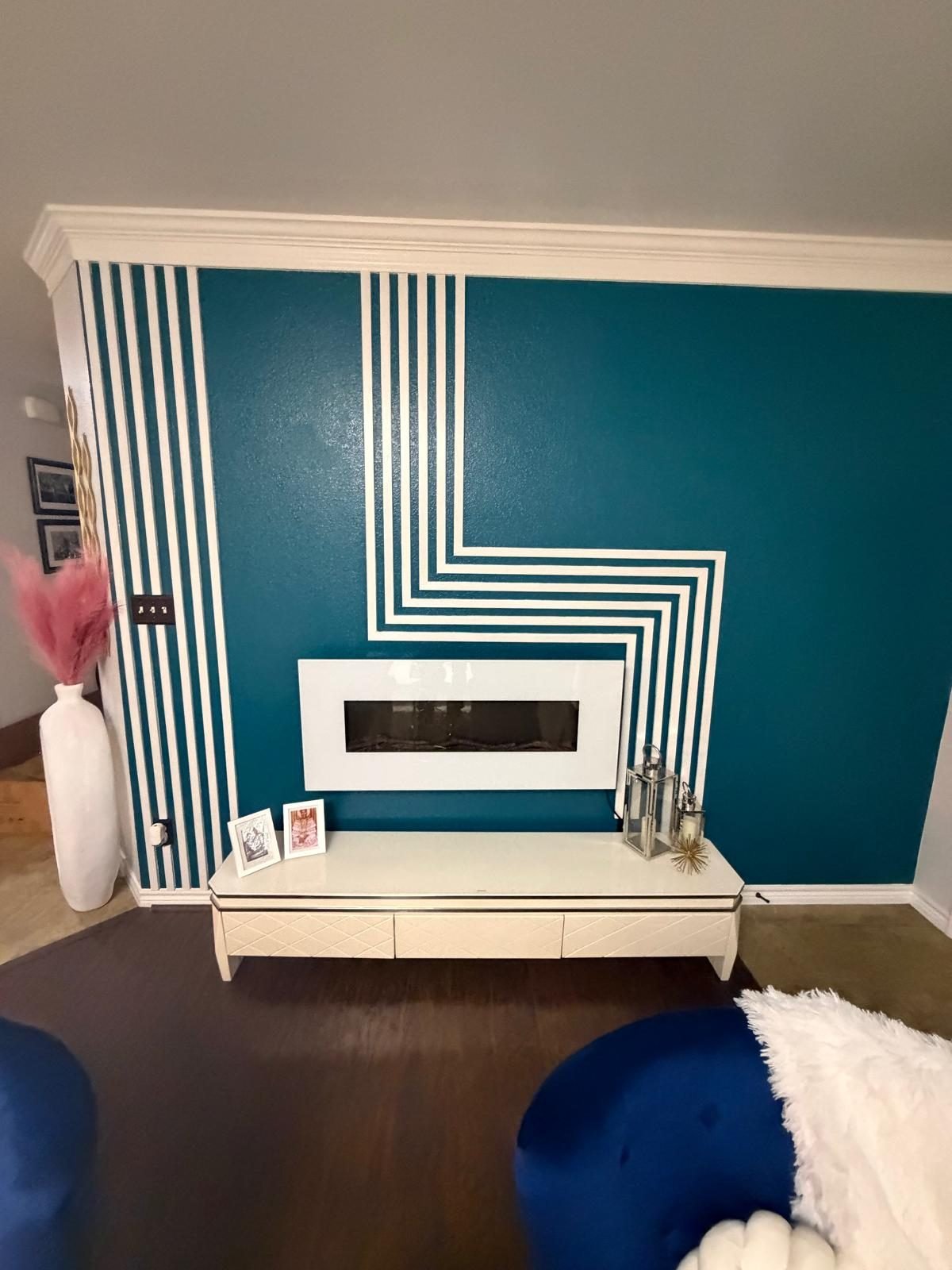 Teal accent wall with white trim